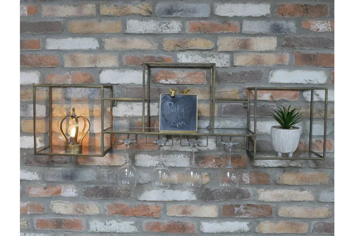 Wall mounted metal wine glass rack with lamp, chalkboard, and potted plant on brick wall
