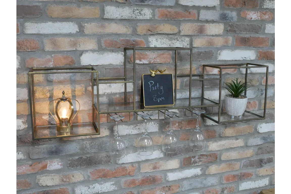 Metal wall shelf with lamp, wine glass holder, potted plant and chalkboard on brick wall