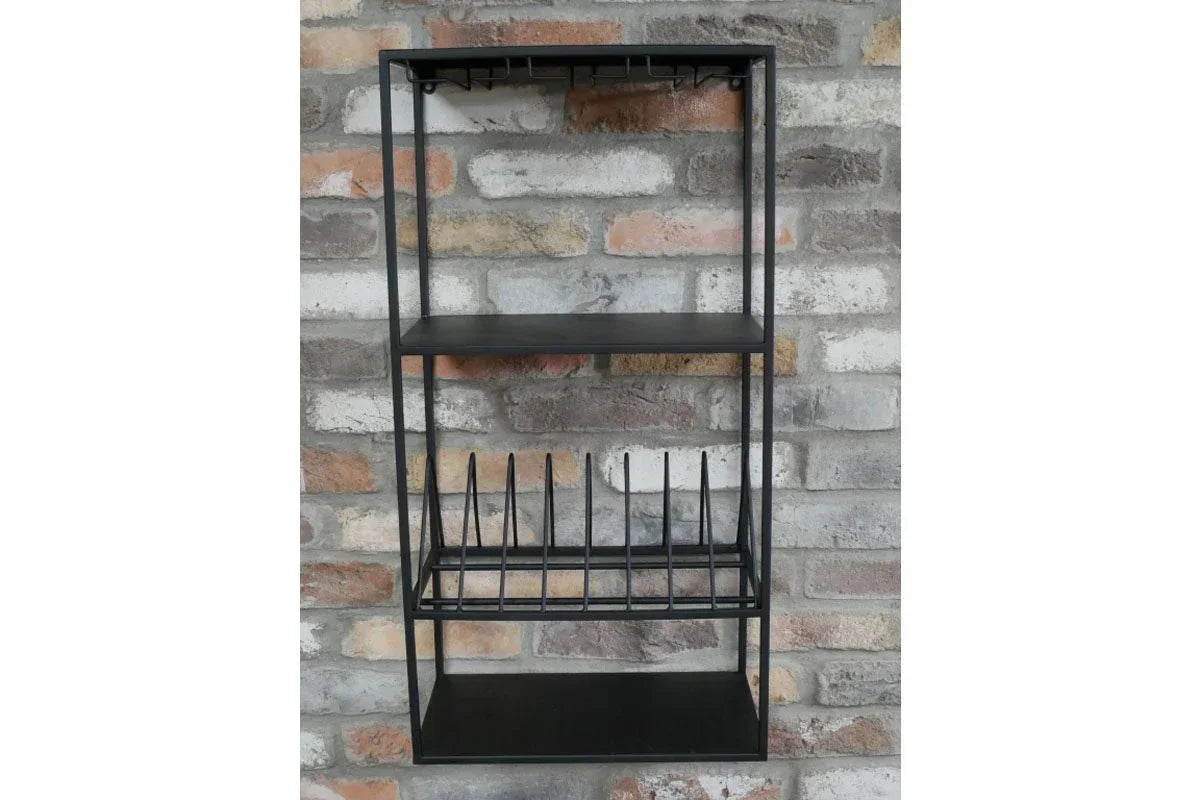 Black metal wall shelf with plate rack and hooks against exposed brick backdrop