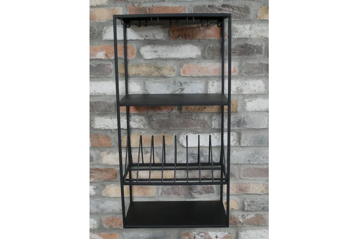 Black metal wall-mounted kitchen rack with shelves and plate holder against brick wall