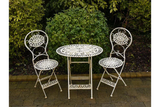White metal bistro set with round table and two chairs on garden patio