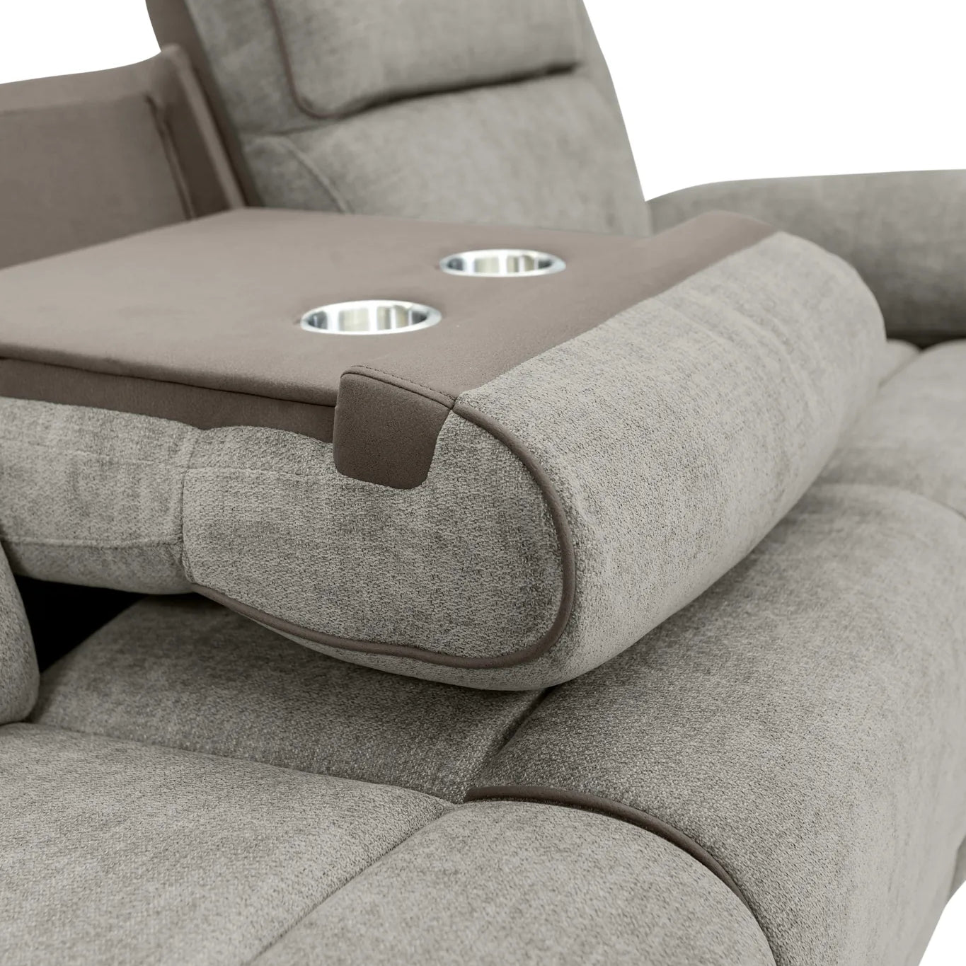 Close-up of a light gray upholstered recliner chair with an extended armrest featuring two cup holders and a brown accent panel.