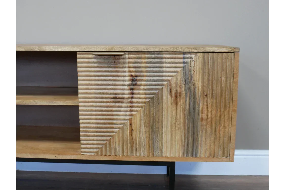 Mango wood TV unit with ribbed geometric cabinet door and open shelves, side angle view