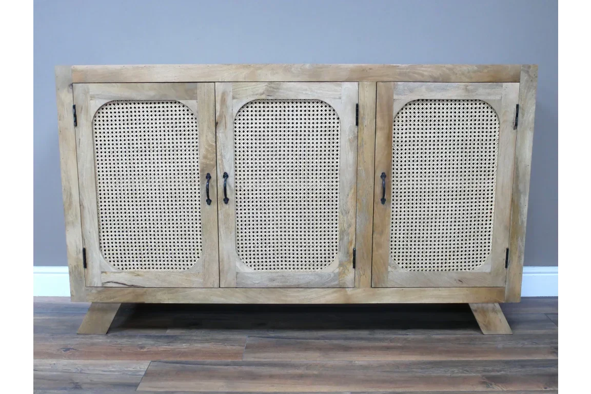 Natural wood sideboard with three cane panel doors and black handles on wood floor
