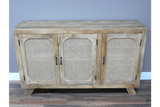 Natural wood sideboard with rattan doors and black handles on laminate floor