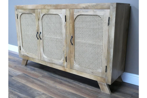 Light wood sideboard with three cane panel doors and angled legs on wooden floor