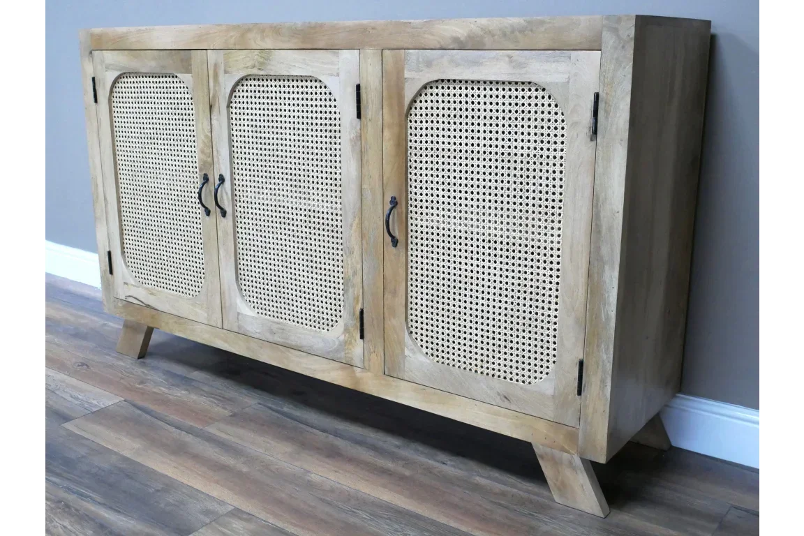 Light wood sideboard with three cane panel doors and angled legs on wooden floor