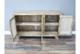 Wooden sideboard with two open cane panel doors and interior shelf on hardwood floor