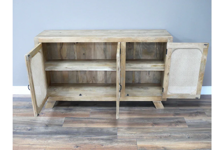 Wooden sideboard with two open cane panel doors and interior shelf on hardwood floor