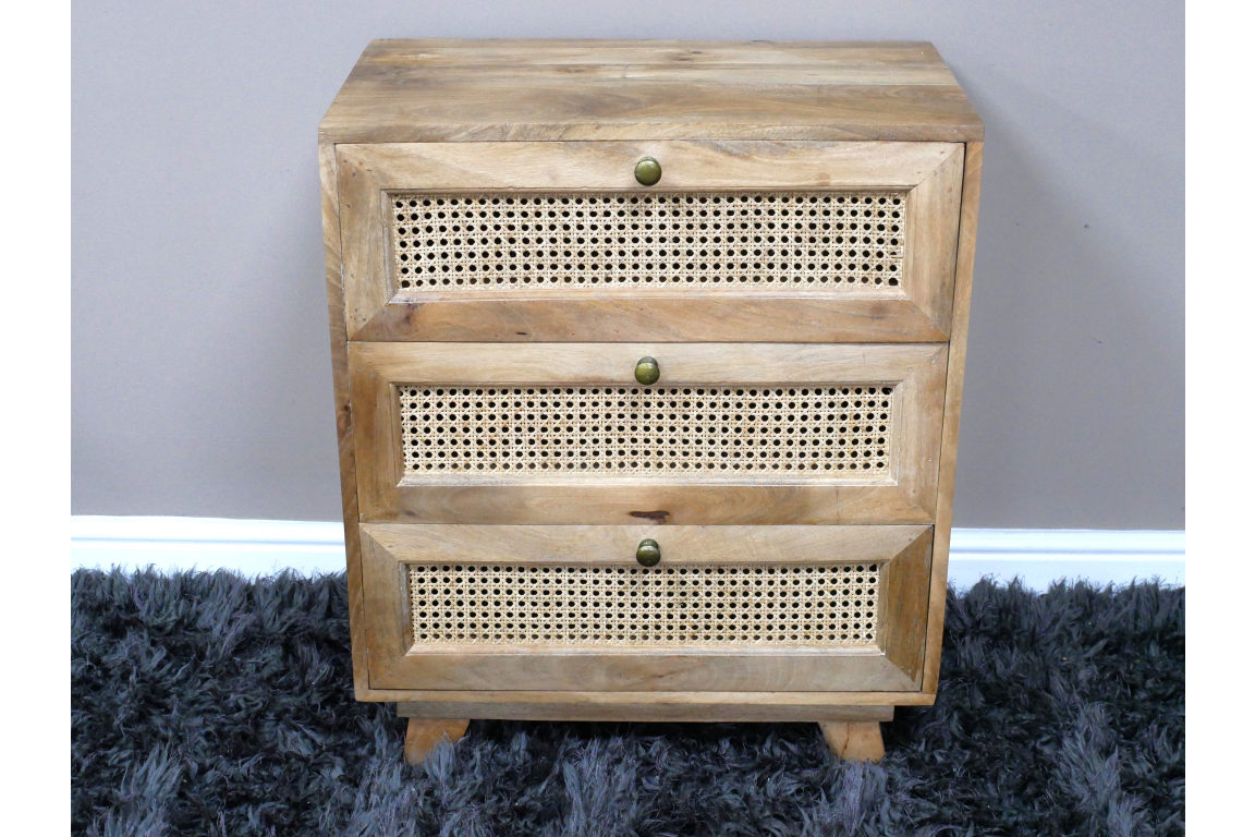 This small chest of drawers features a natural wood finish with three woven rattan front drawers and round brass knobs, perfect for stylish storage in any room