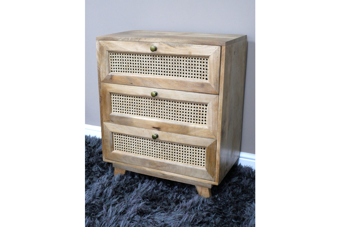 This small chest of drawers features a natural wood finish with three woven rattan front drawers and round brass knobs, adding a stylish touch to any space