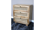 This small chest of drawers features a natural wood finish with three woven rattan front drawers and round brass knobs, adding a stylish touch to any space