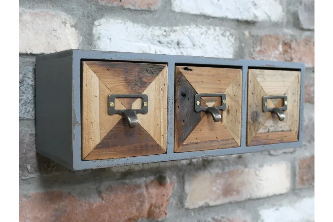 Wall mounted wooden storage unit with three geometric drawers and metal handles
