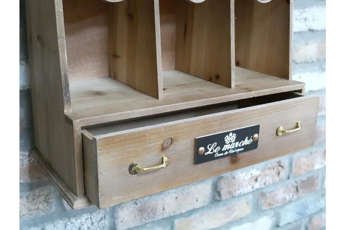 Wooden wall organiser with brass handles and label, featuring open compartments and drawer