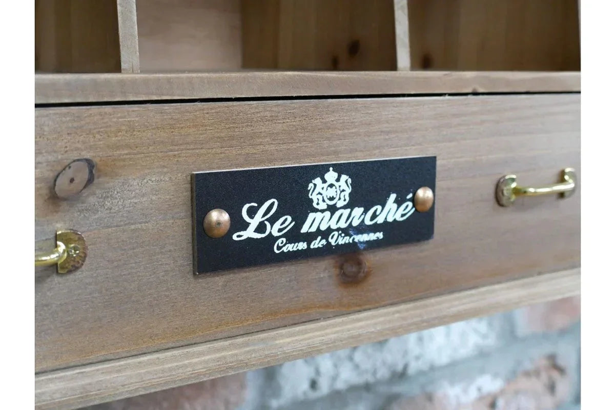 Rustic wooden drawer with brass handle and Le Marché label, part of storage furniture