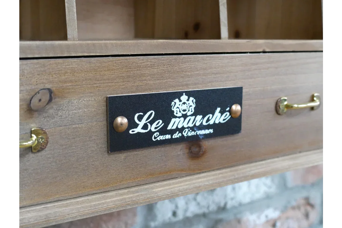 Wooden storage unit drawer with brass handles and Le marché label