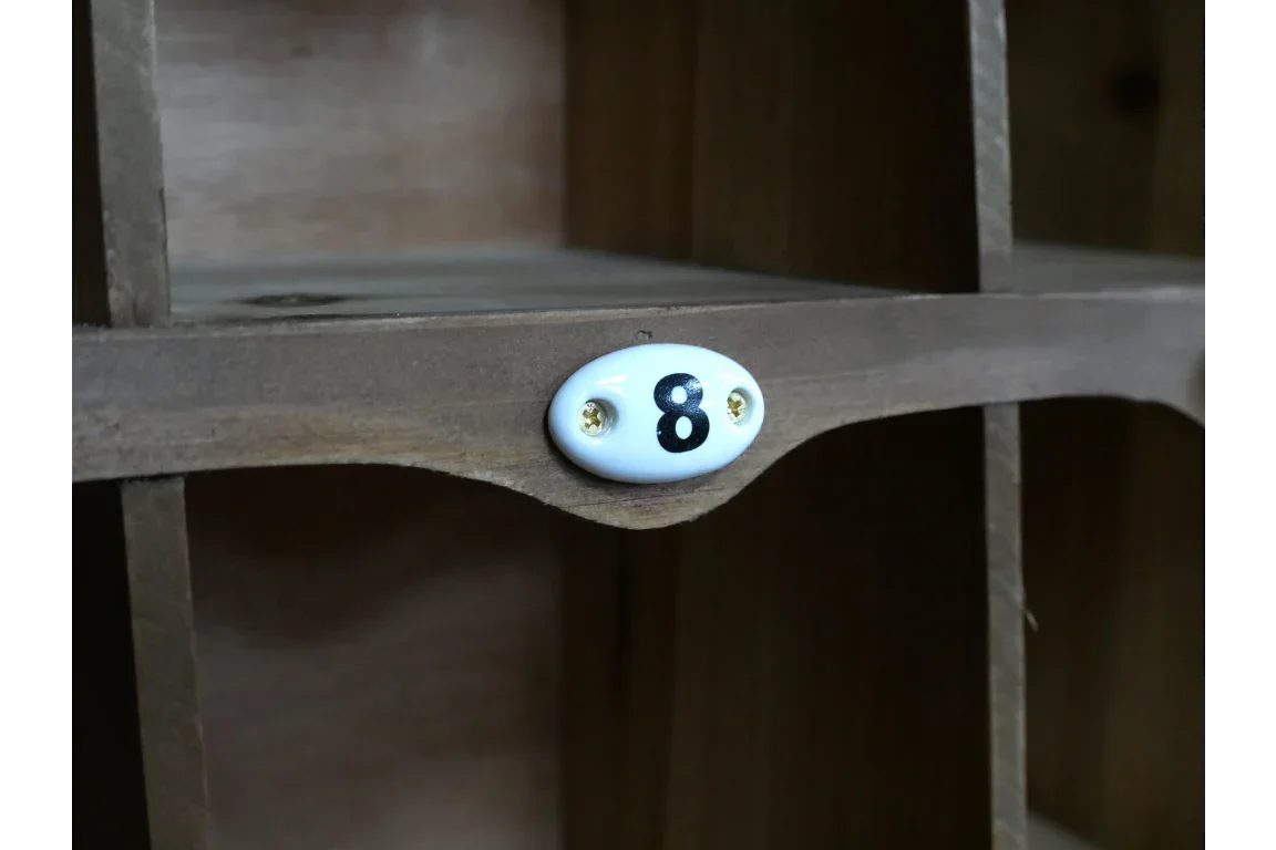 Wooden storage cubby shelf with numbered ceramic label and natural finish