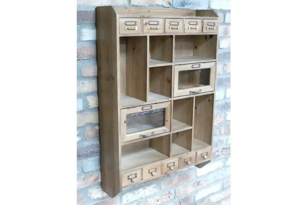 Rustic wooden wall organizer with small drawers and open shelves, mounted on brick wall