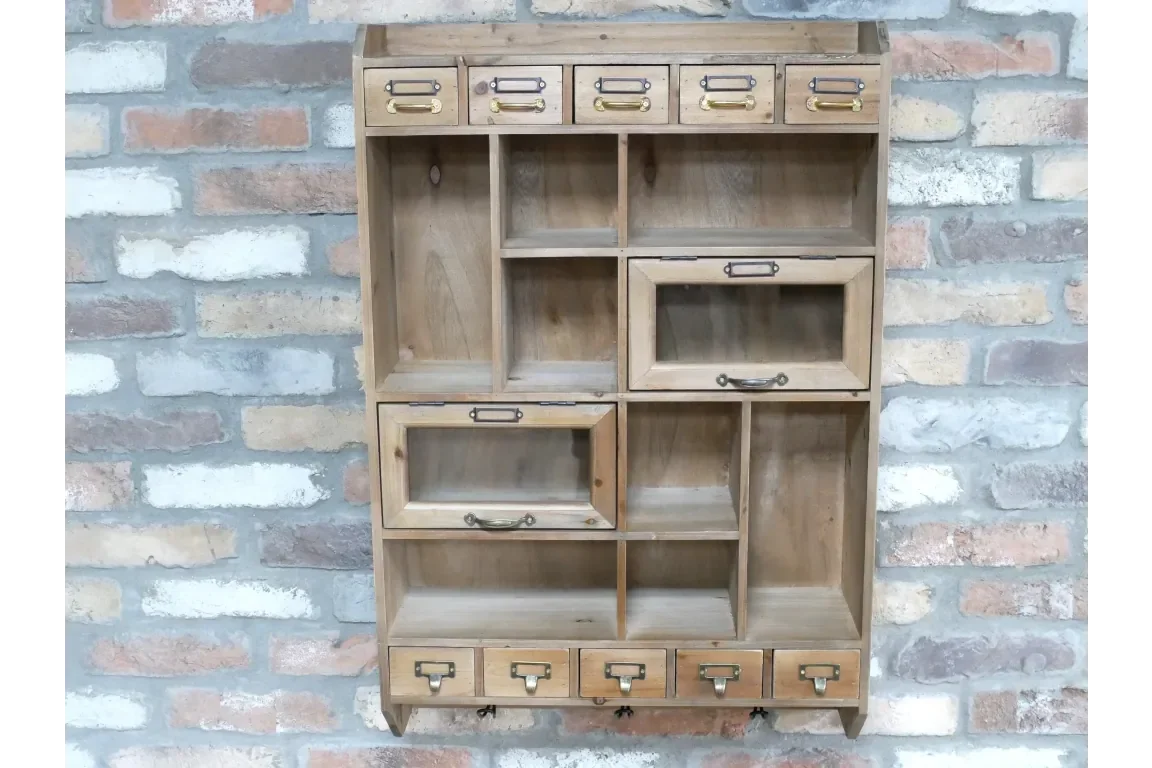 Wooden wall shelf unit with multiple drawers and compartments against brick background