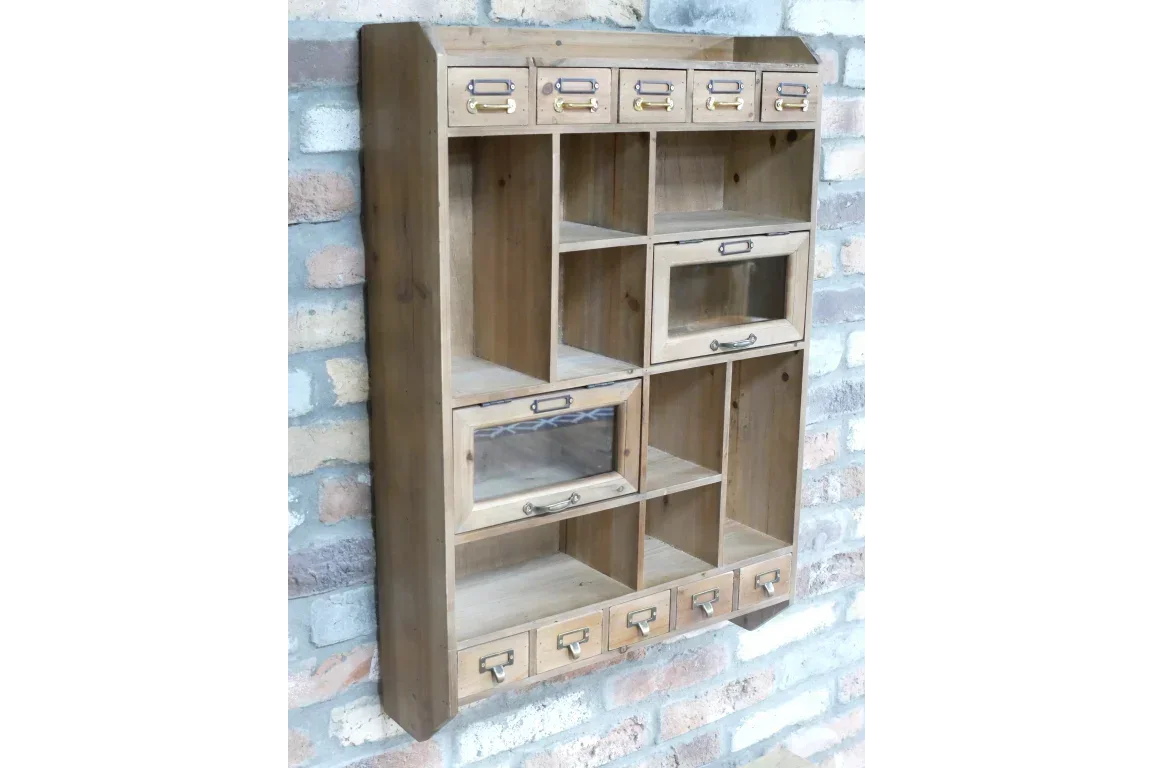 Wooden wall mounted storage unit with drawers and cubby shelves against brick wall