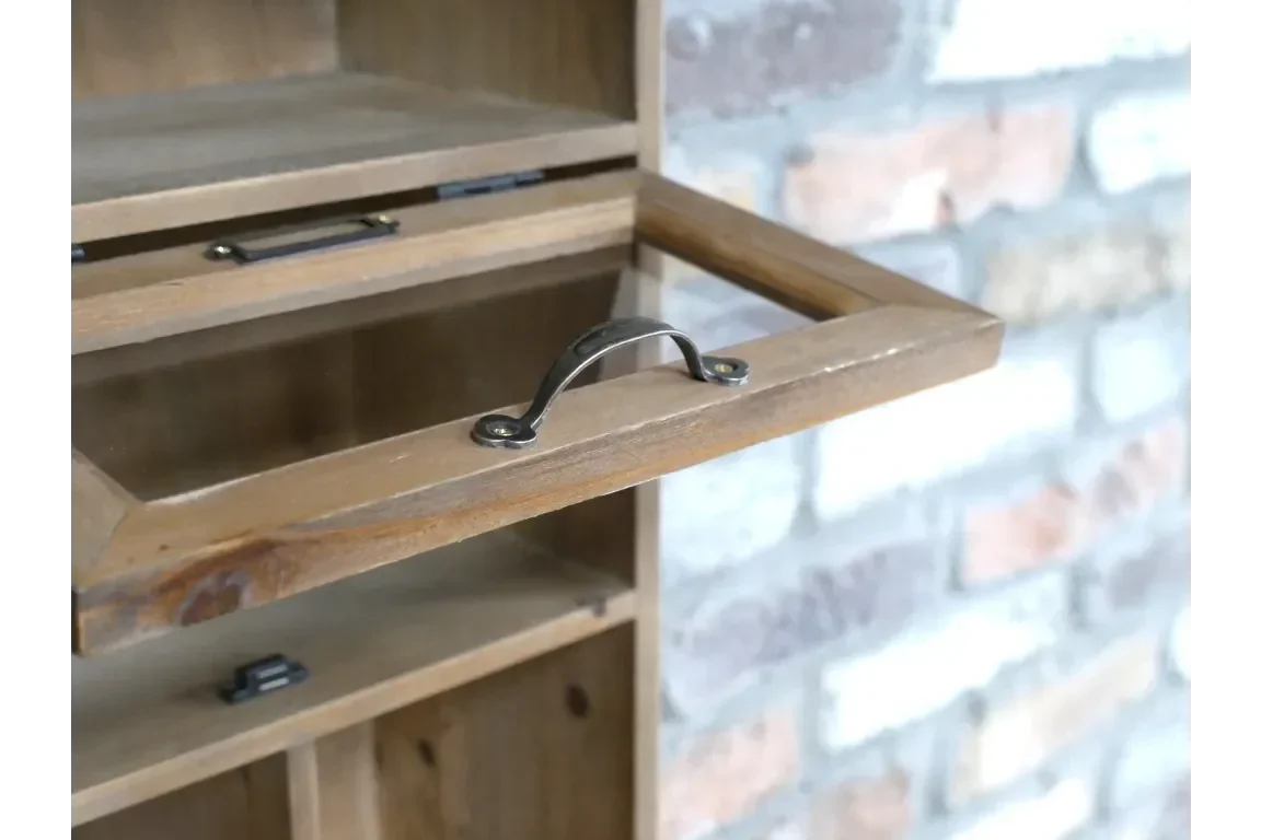 Wooden cabinet closeup showing metal handle and drop-down storage compartment
