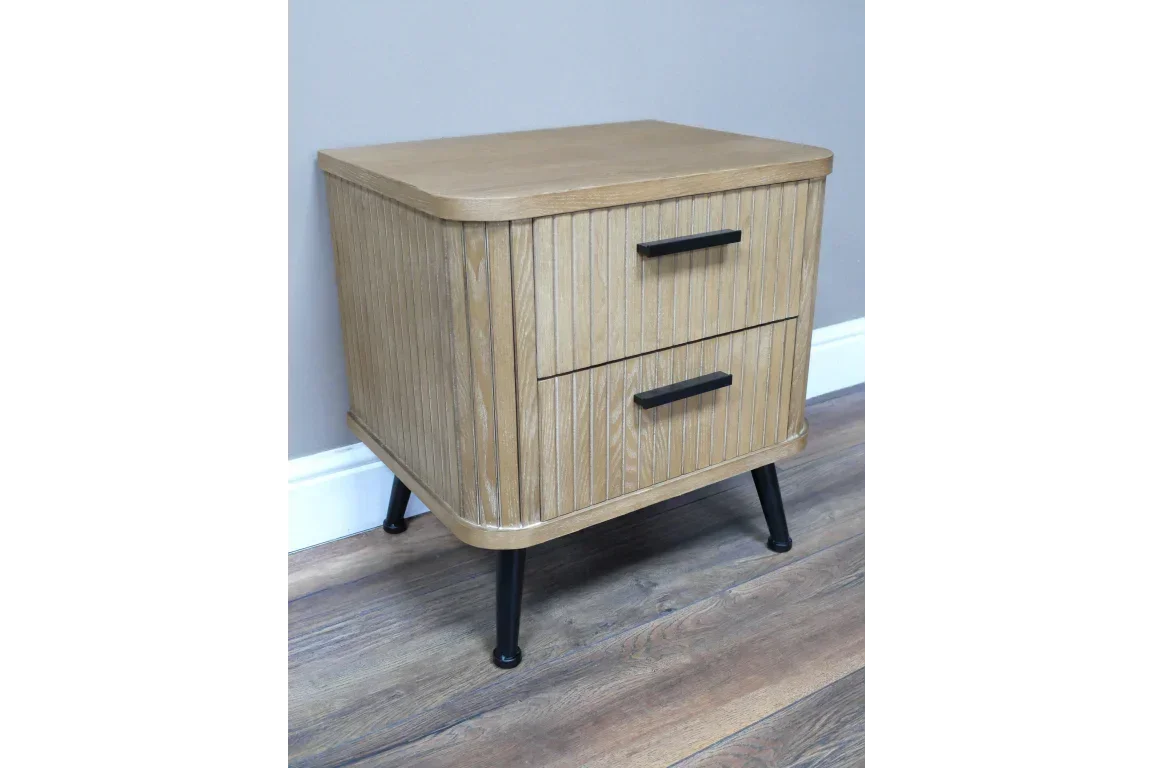 Wooden bedside table with two drawers and black handles on angled legs