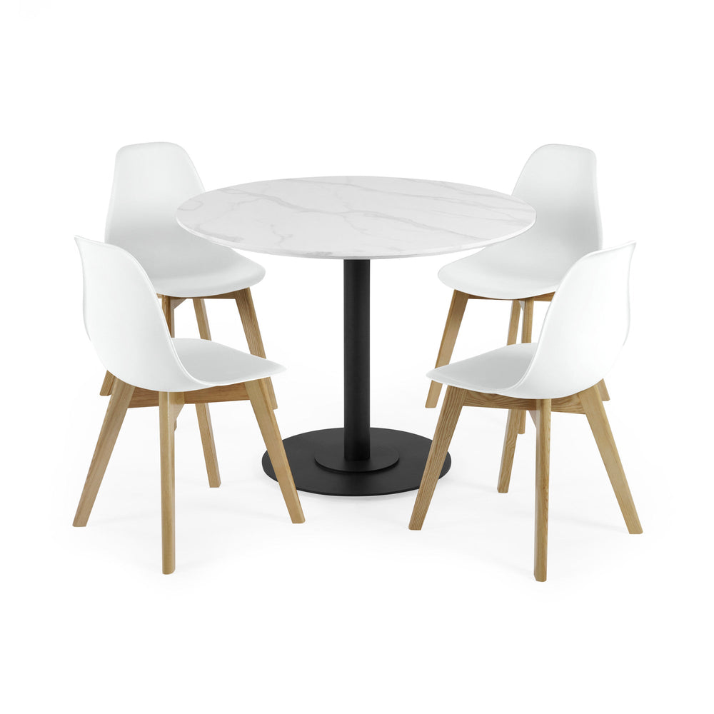 Four white chairs with light wood legs around round white marble table with black base