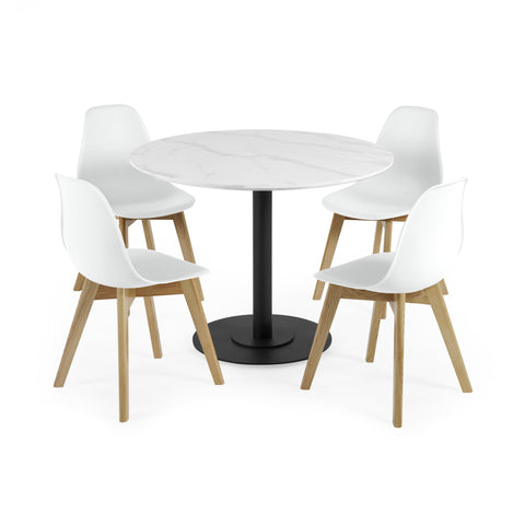 Four white chairs with light wood legs around round white marble table with black base