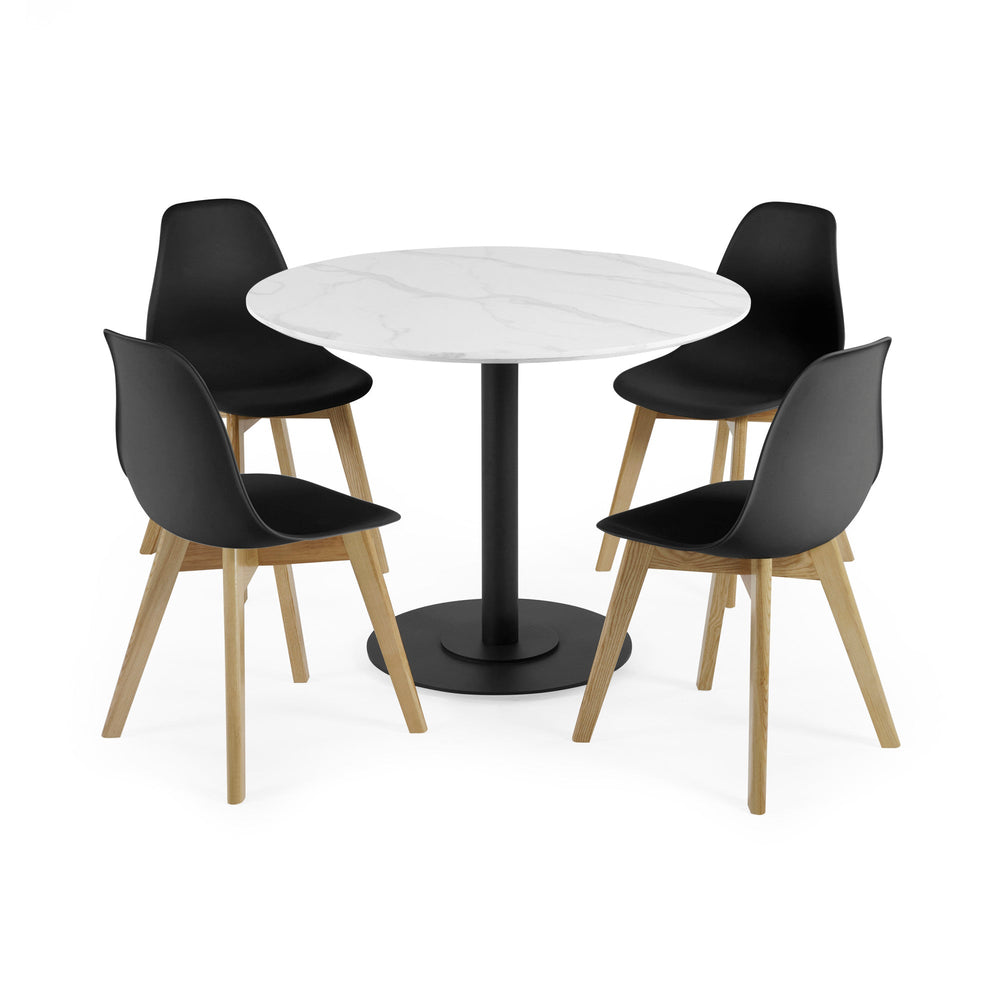 Four black chairs with wooden legs around round white marble table with black pedestal base on white background