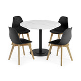 Four black chairs with wooden legs around round white marble table with black pedestal base on white background