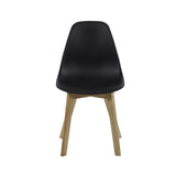 Dining chair with matte black seat and light wood legs front view on plain white background.
