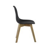 Side profile of dining chair showing curved black seat and natural wooden legs against white background.