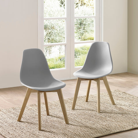 Two light grey plastic chairs with light wooden legs on wooden floor in minimal room with glass doors