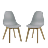 Pair of light grey plastic chairs with light wooden legs on white background side by side