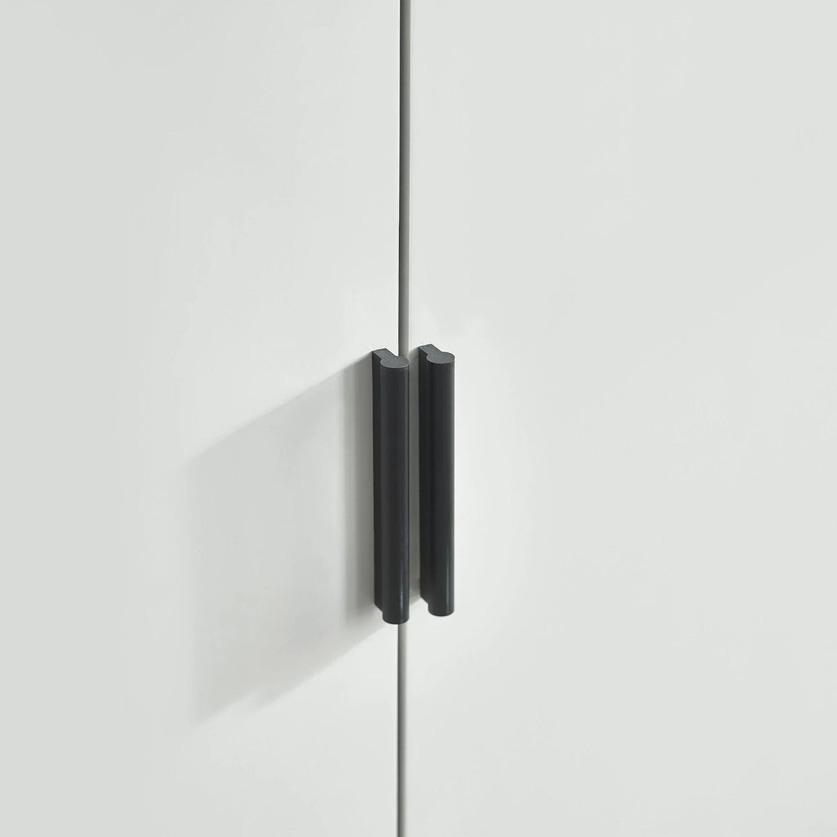Silk grey two door wardrobe close-up showing modern black handles
