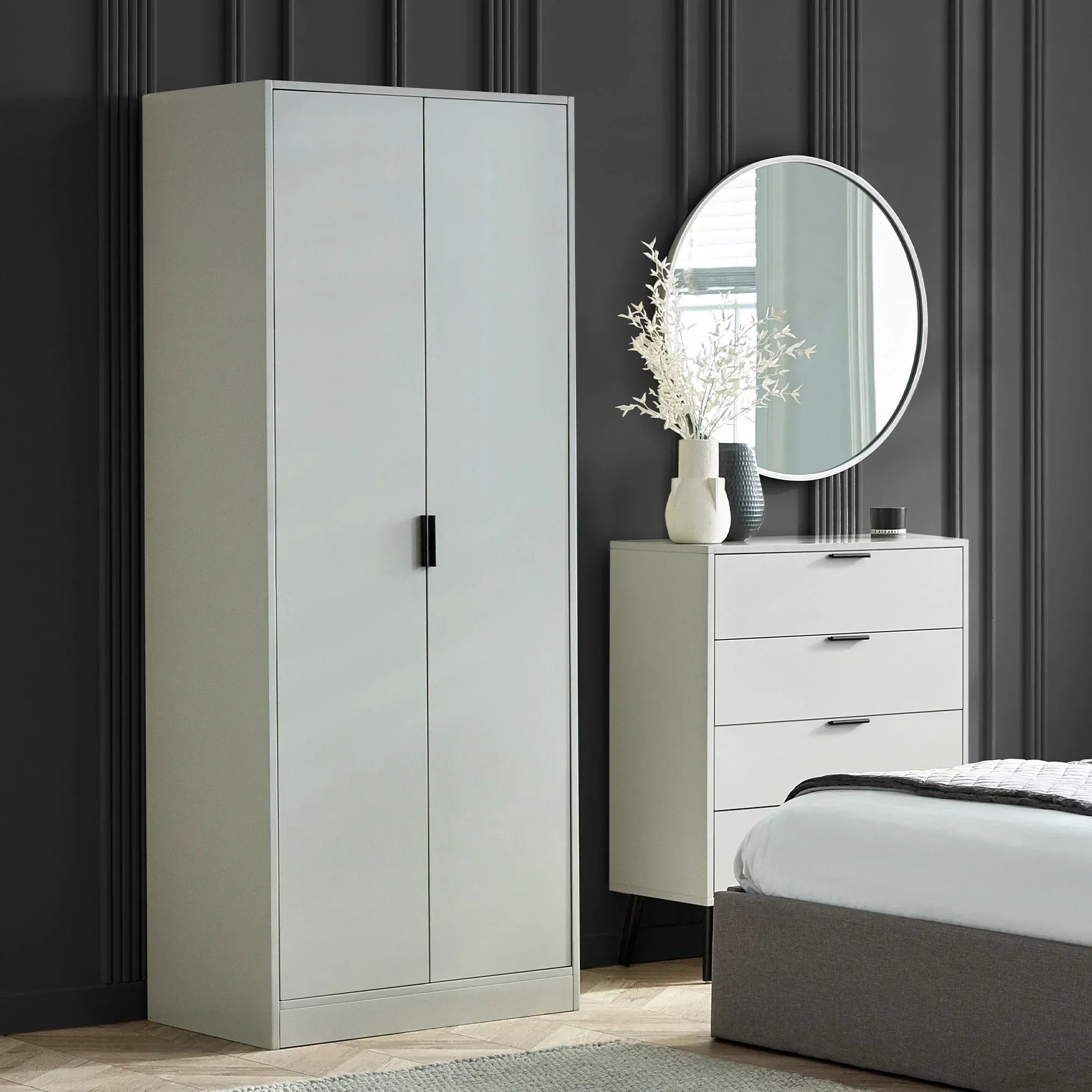 Silk grey 2 door wardrobe in modern bedroom with matching drawers and round wall mirror