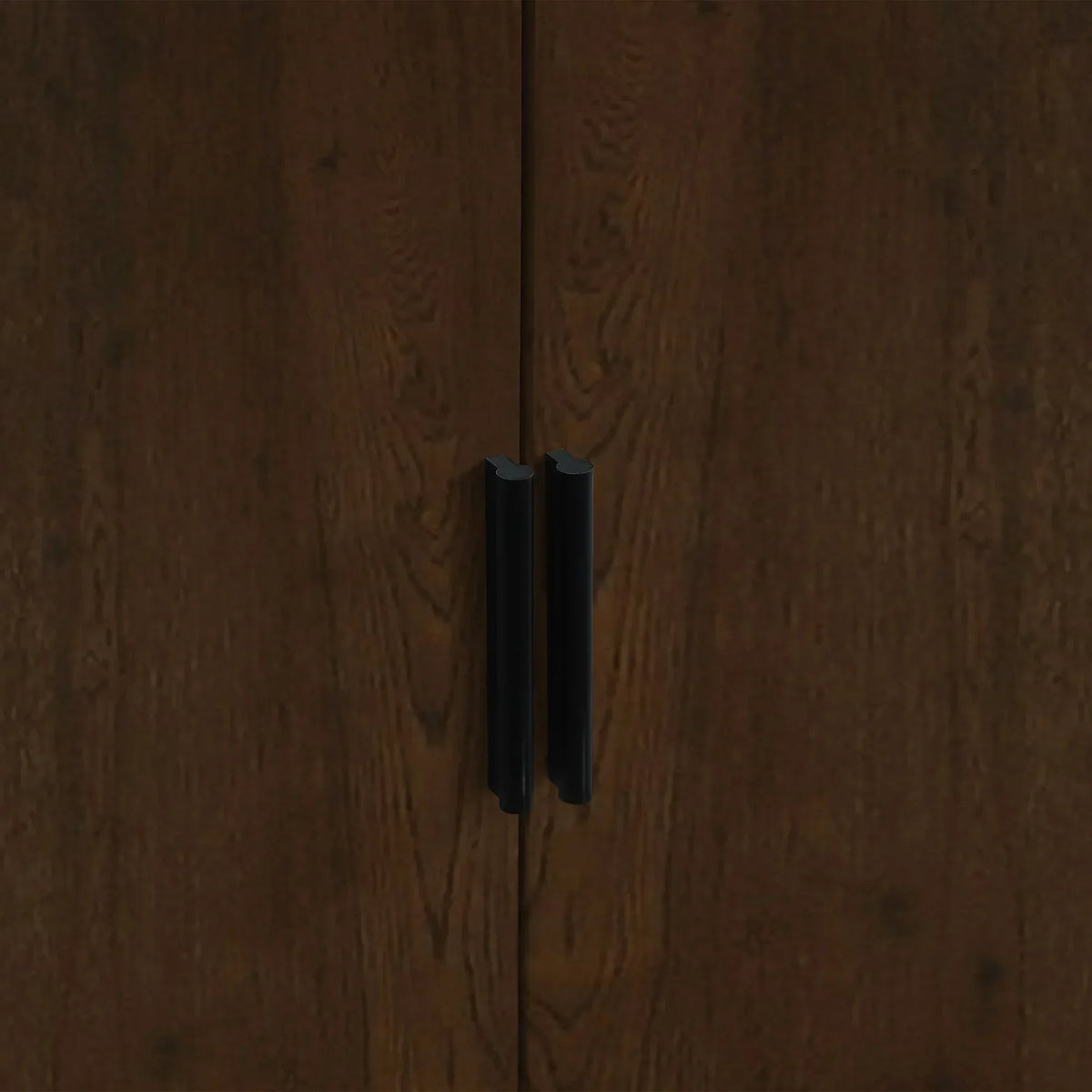 Walnut wardrobe doors with black handles close up