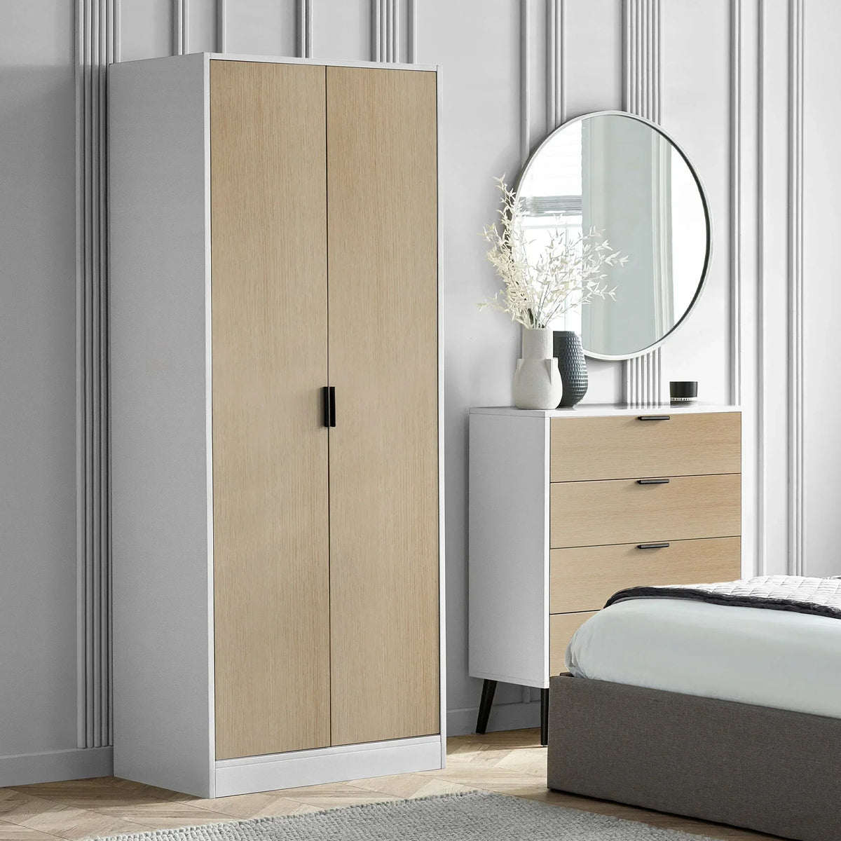 White and oak two door wardrobe beside matching chest of drawers in modern bedroom