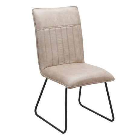 A modern dining chair with a light beige textured fabric upholstered seat and backrest featuring vertical channel tufting, supported by a black metal cantilever frame, shown on a plain white background.