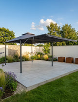 Grey metal garden gazebo with canopy on paved patio surrounded by plants
