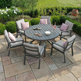 Grey aluminum outdoor dining set with round table and cushioned chairs on patio