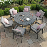 Aluminium garden dining set with grey cushions and round table on stone patio
