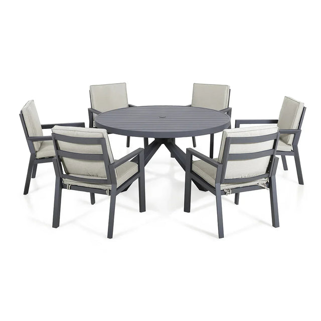 Grey aluminum outdoor dining set with round table and six cushioned chairs
