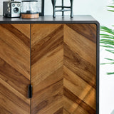 Chevron wood pattern sideboard with black metal trim and decorative items on top