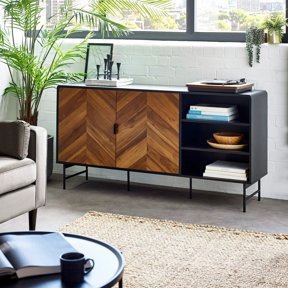 Modern sideboard with chevron wood doors and black frame in contemporary living room