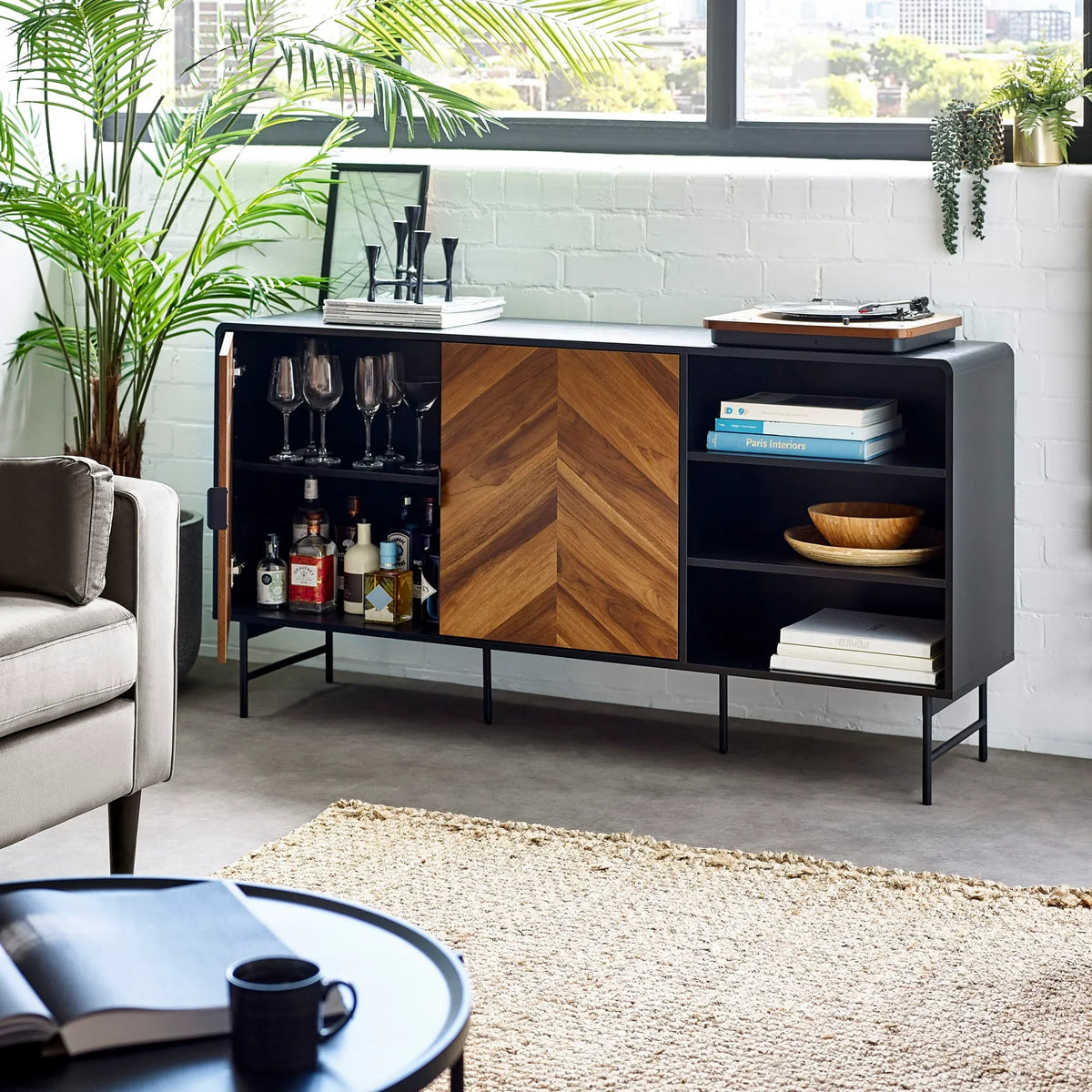 Modern sideboard with black frame, wood chevron doors, open shelves and drinks storage