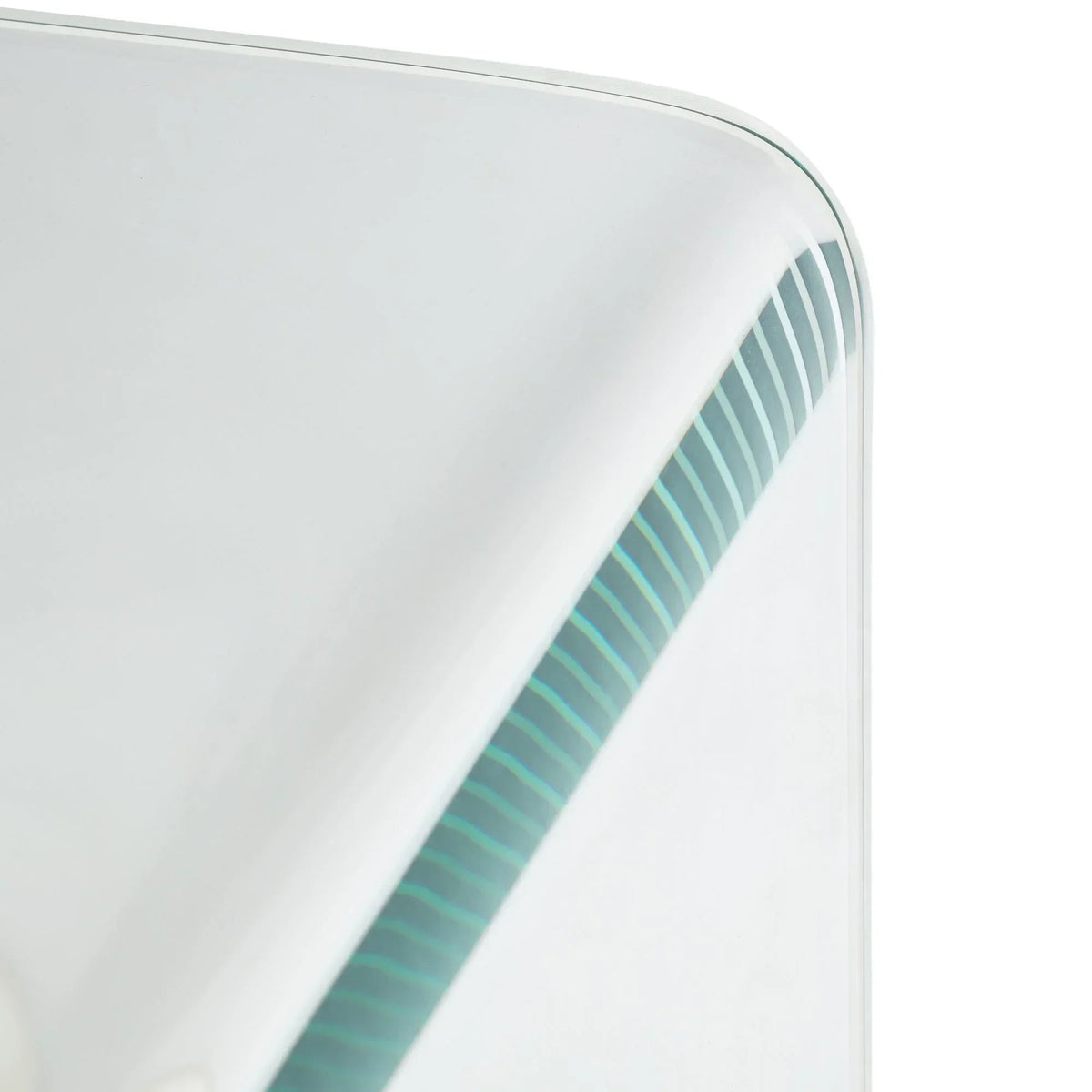 Close up of glass desk corner with rounded edge and visible striped detail