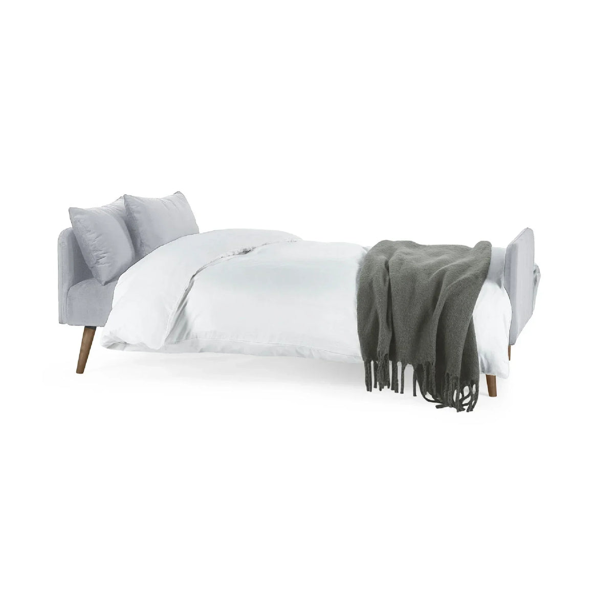 Grey sofa bed extended with cushions, white bedding, and dark throw blanket