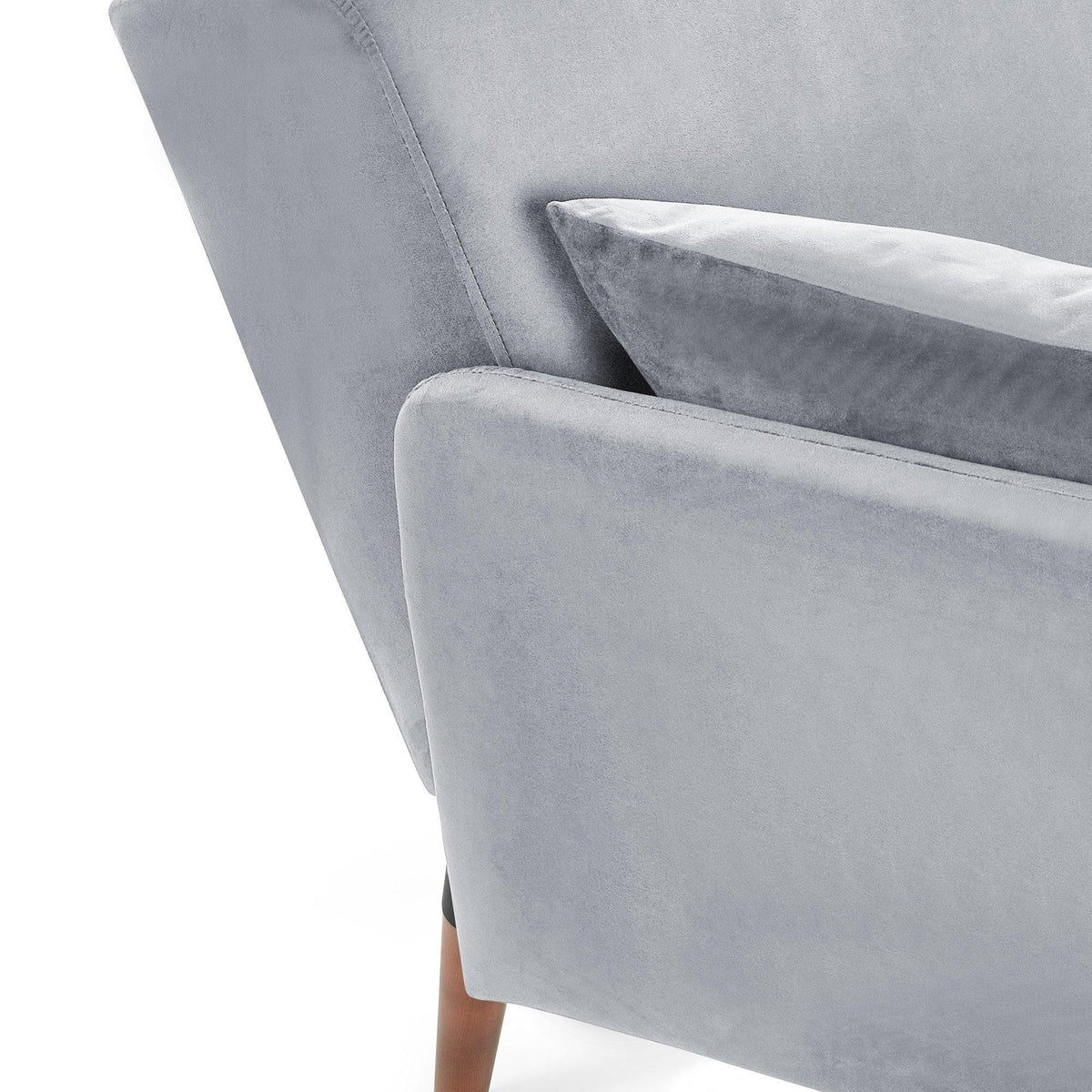 Grey fabric sofa bed corner with cushion and wooden leg detail