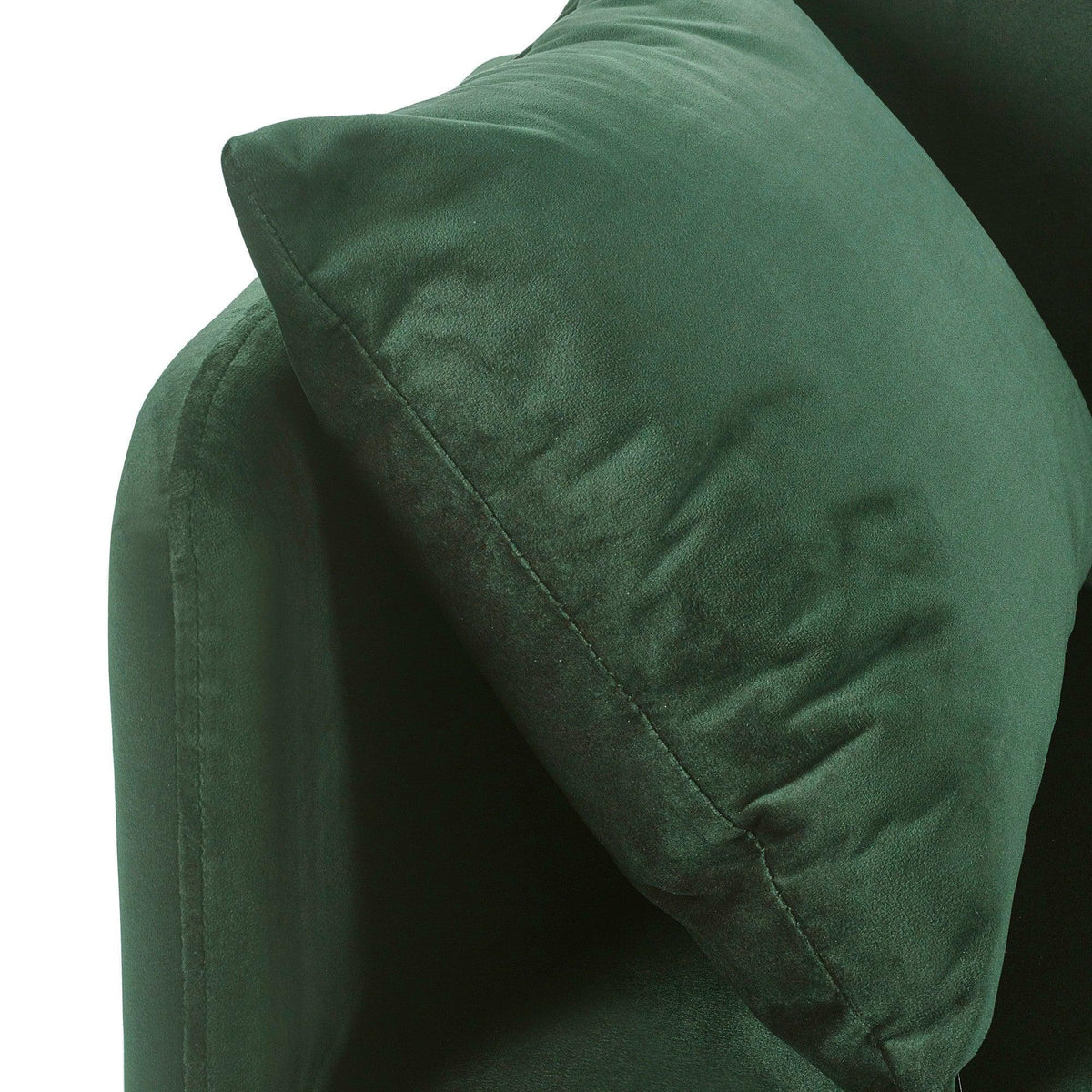 Close-up of green velvet sofa bed cushion and armrest detail